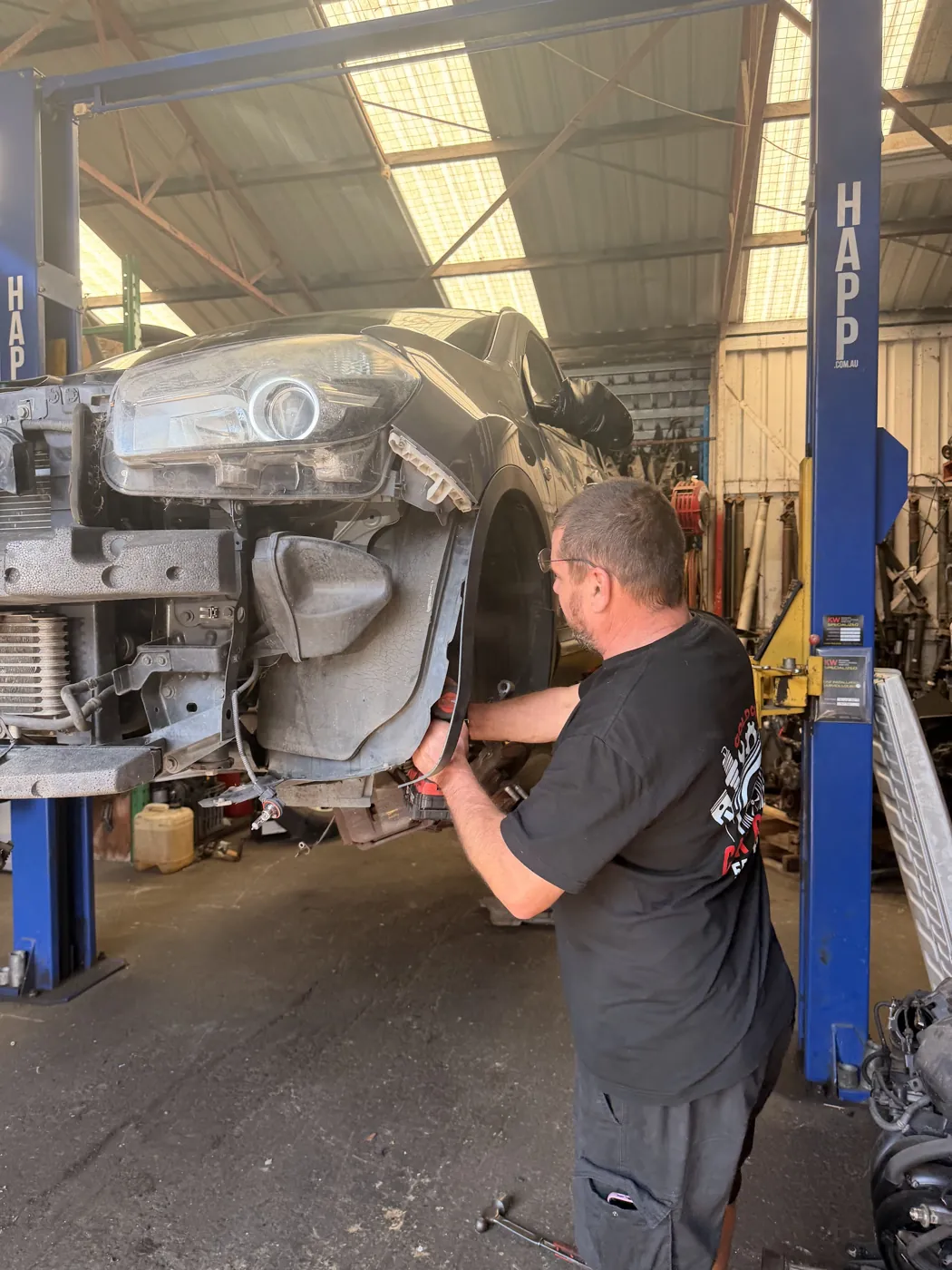 Gold Coast Car Parts staff removing a part in the Molendinar workshop